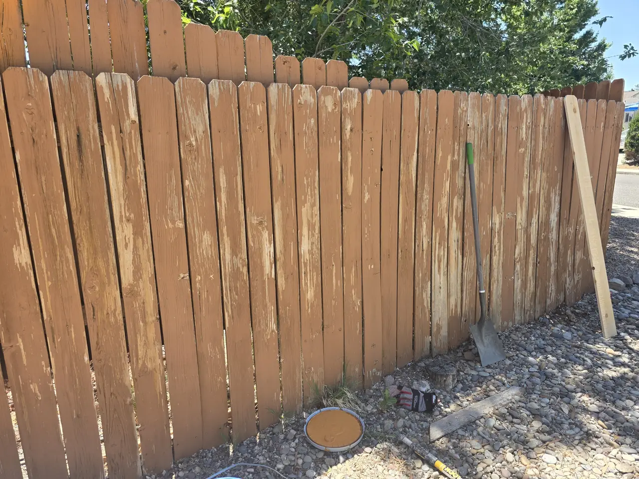 Before: weathered, faded fence pickets on the same property