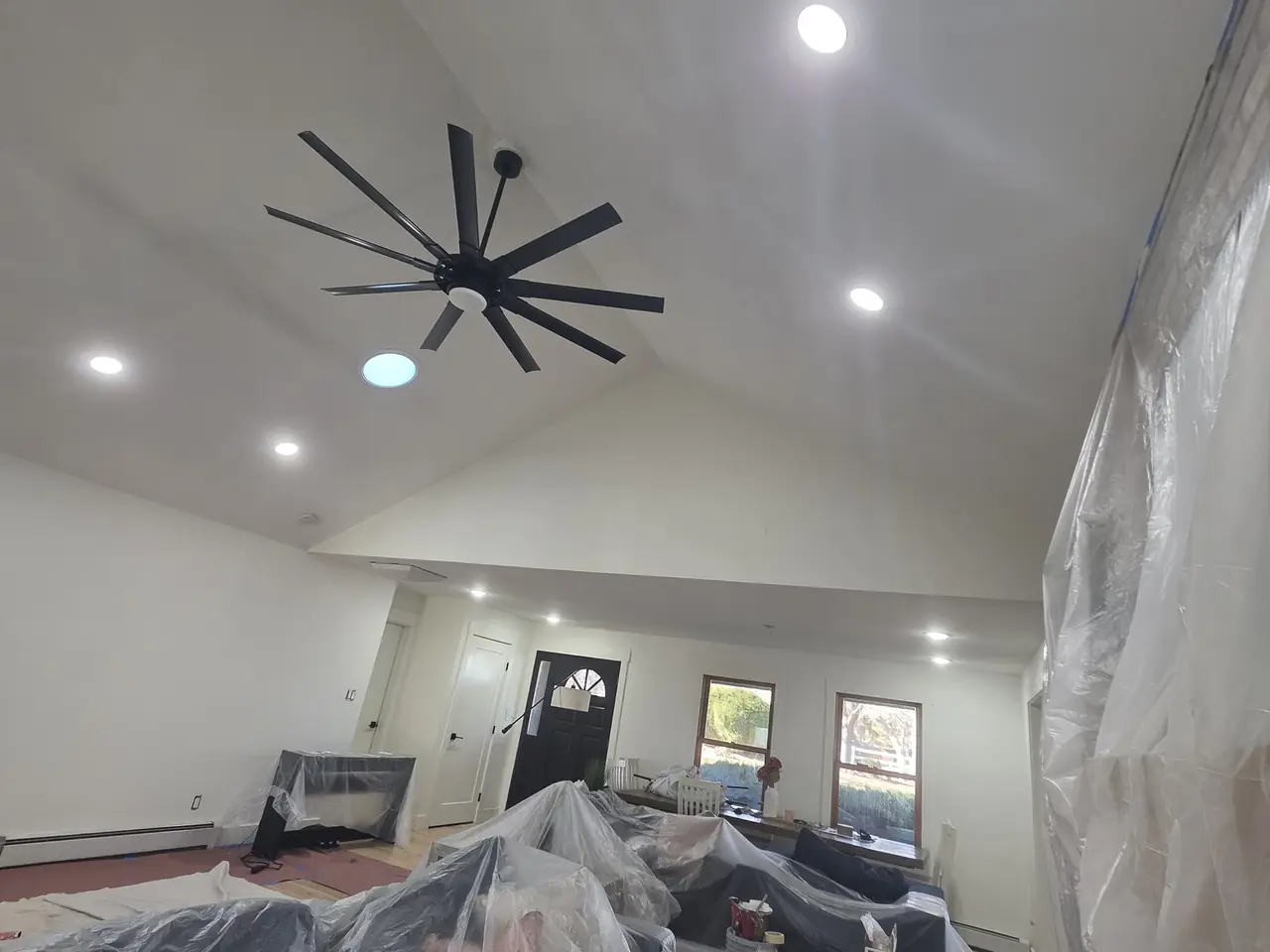 Before: the same great room mid-project with furniture covered in plastic