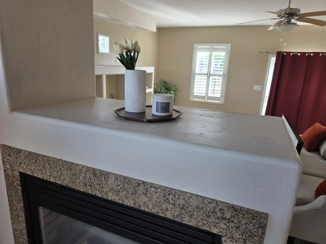 Living room with freshly painted walls and fireplace surround