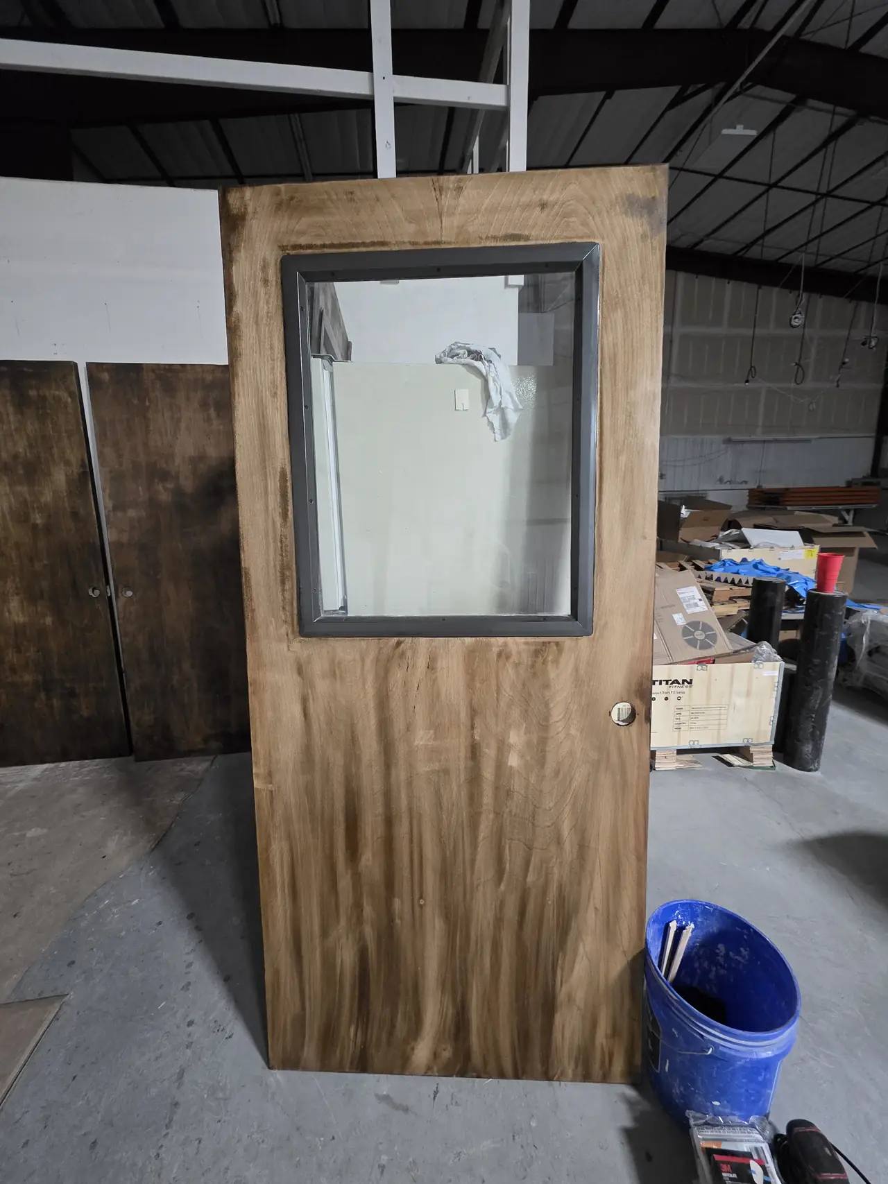 Commercial-style door mid-way through a stain refinish